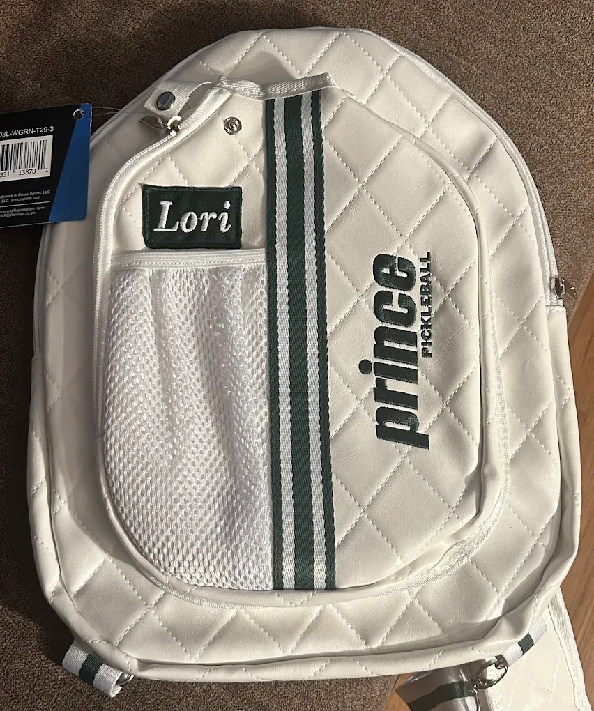White pickleball backpack with a green name patch reading Lori