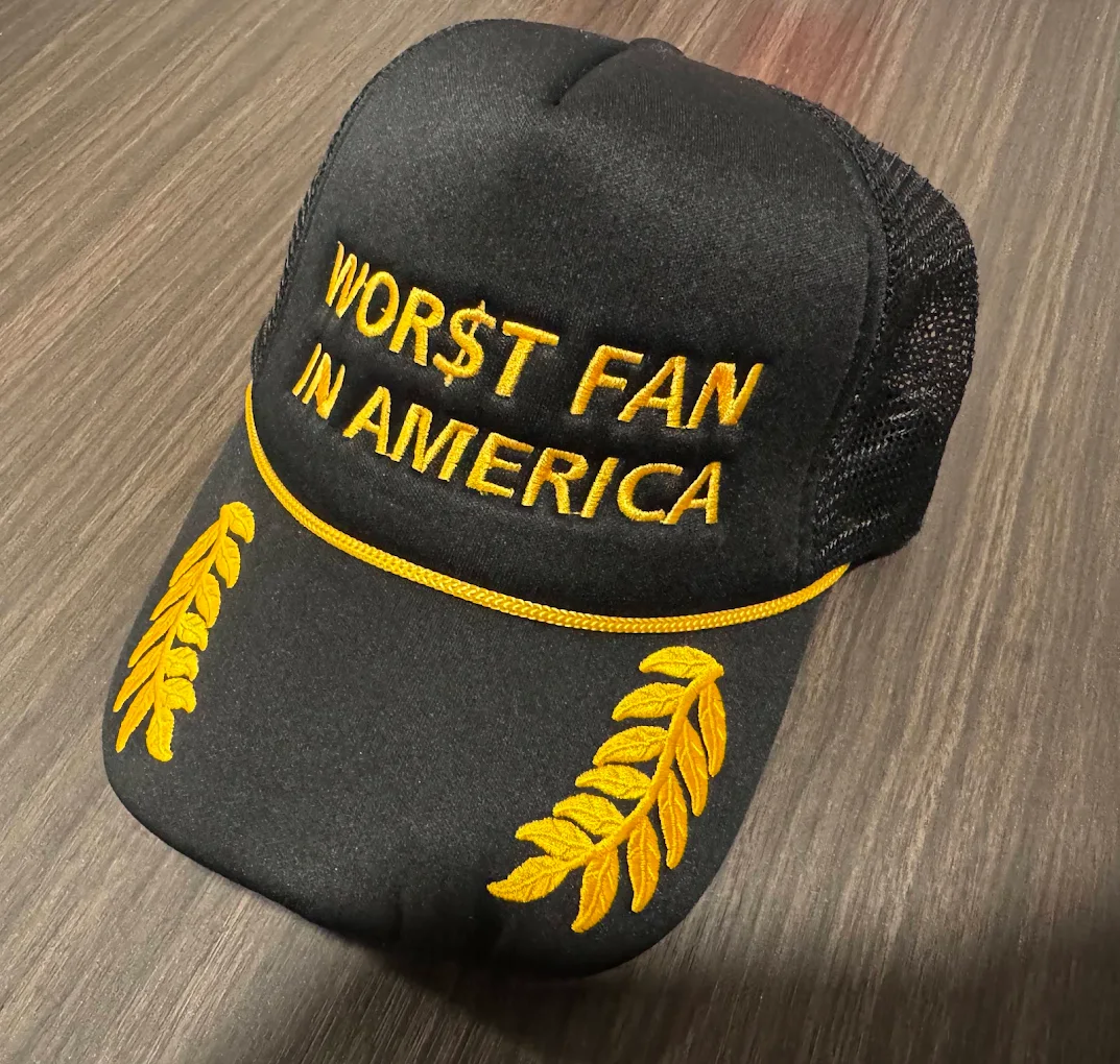Custom black trucker hat with gold 3D puff lettering and laurel embroidery